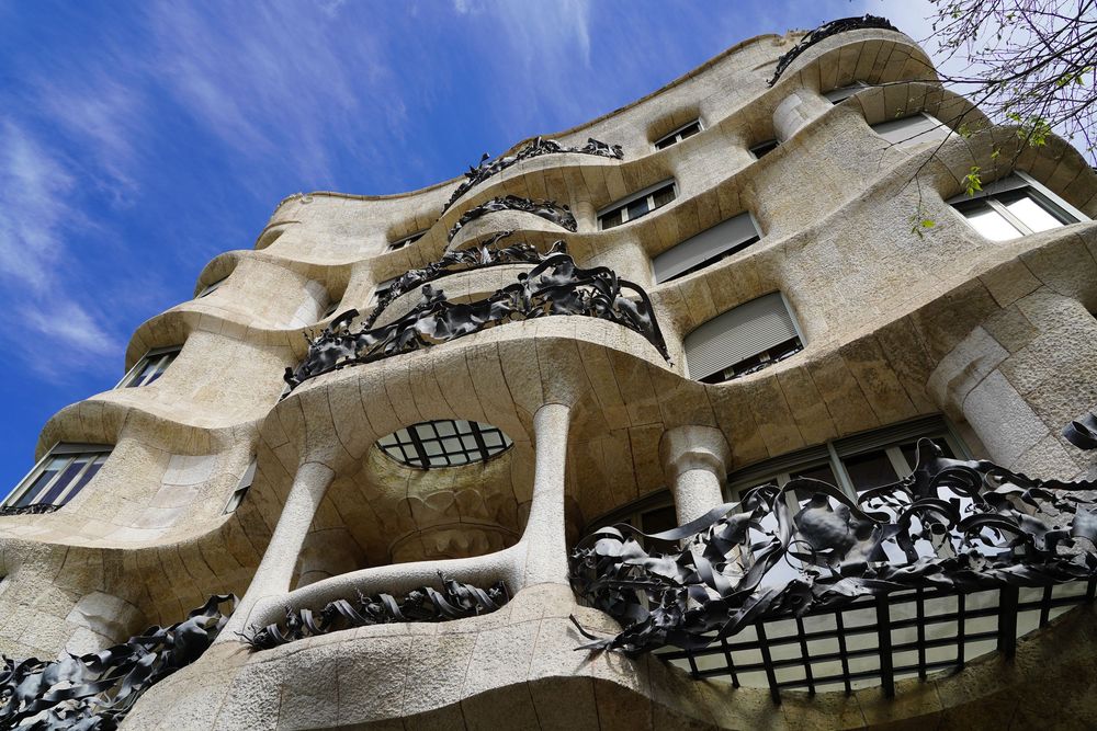 Casa Mila's distinctive wavy stone facade and wrought iron balconies showcase Gaudi's unique architectural style in Barcelona.