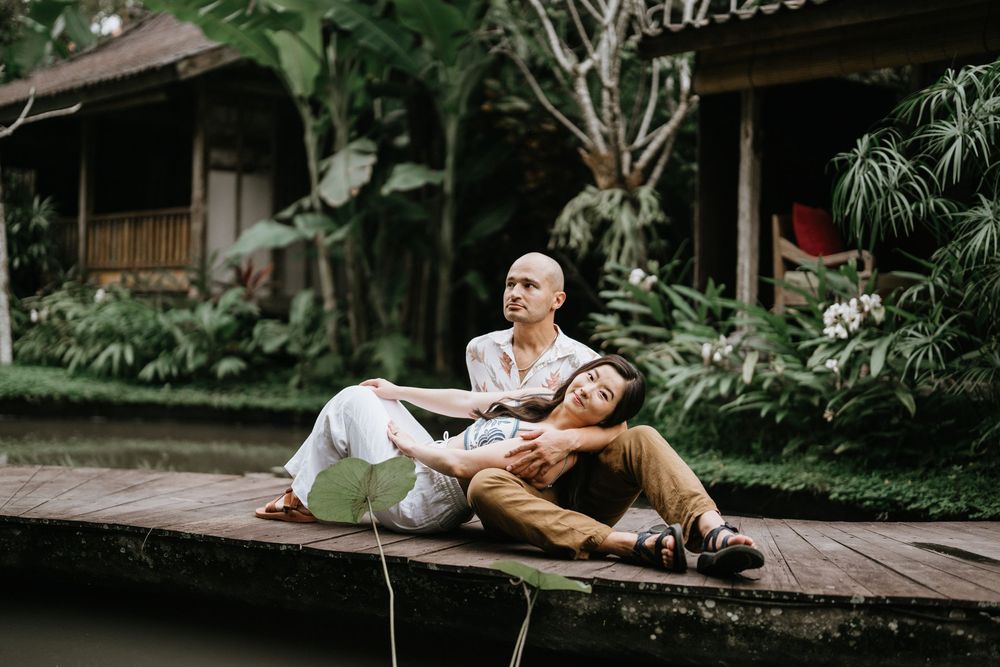Candid moments captured during a couple's photoshoot in a lush garden setting.