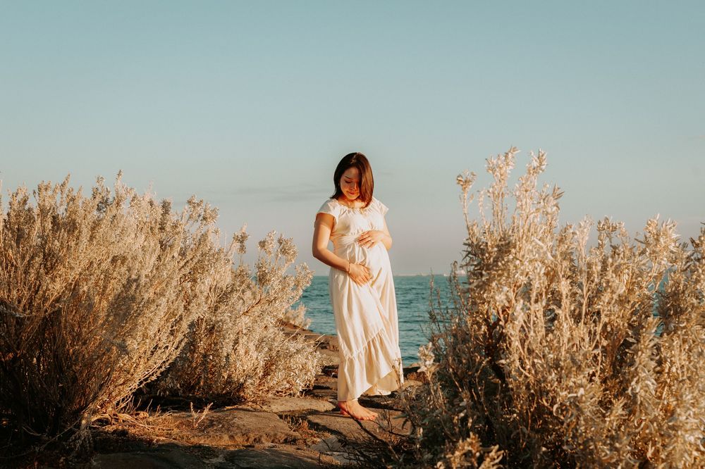 A maternity photo session on the beach with golden shrubs and path, in soft sunlight.
Altona Maternity Photographer Melbourne