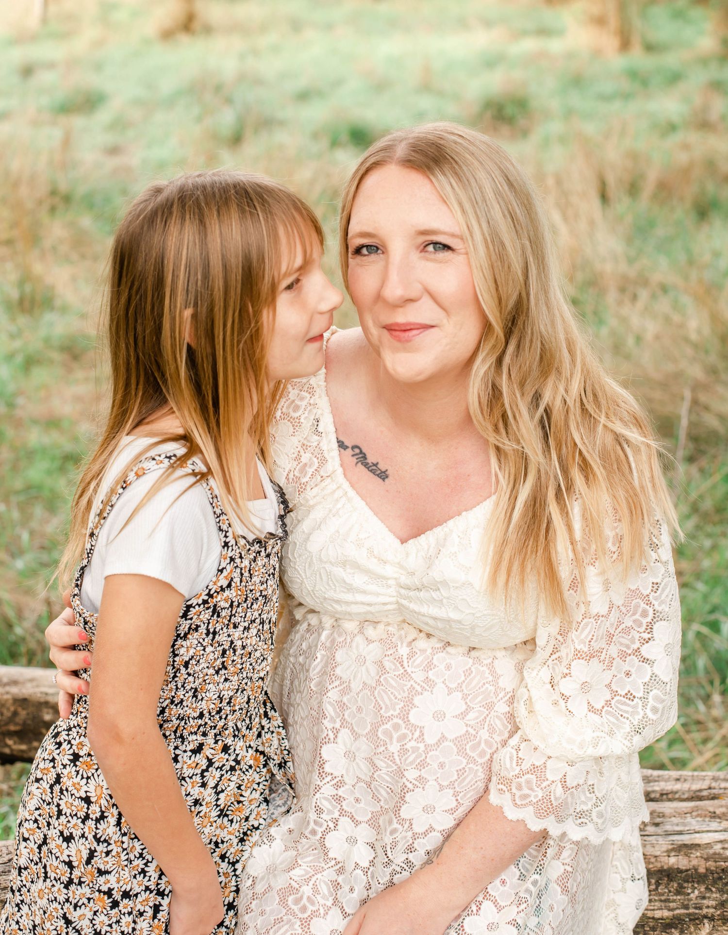 Mother and daughter share tender moments in a series of outdoor portraits wearing white and floral dresses.