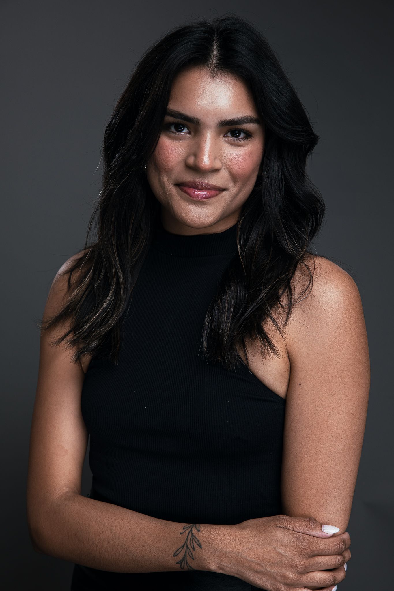 Portrait series showing poses in black jacket and white shirt against warm-toned background.