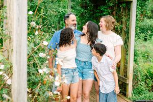 Family enjoying a summer day together outdoors against a lush green natural background.