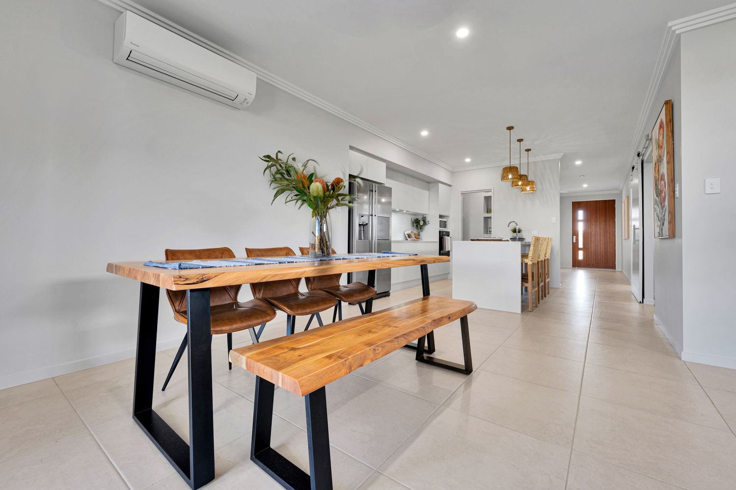 Spacious modern apartment interior with wooden accents and tiled flooring.