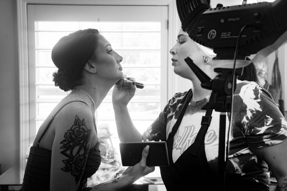 Black and white image of wedding day makeup preparation.
