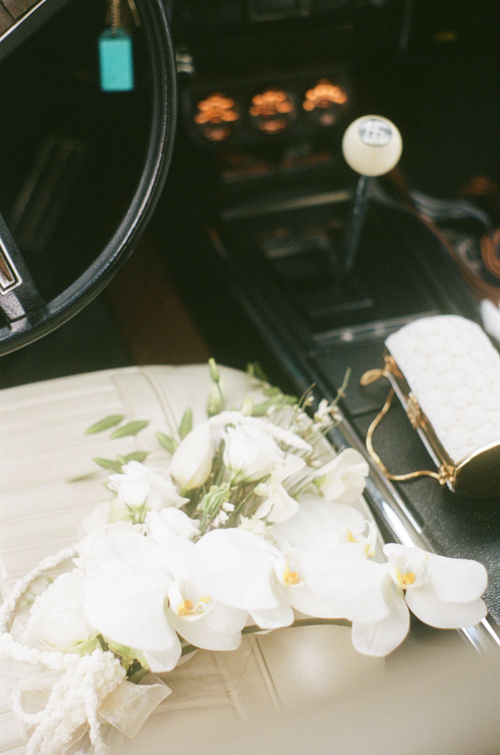 White orchids arranged on a dark surface with soft lighting.