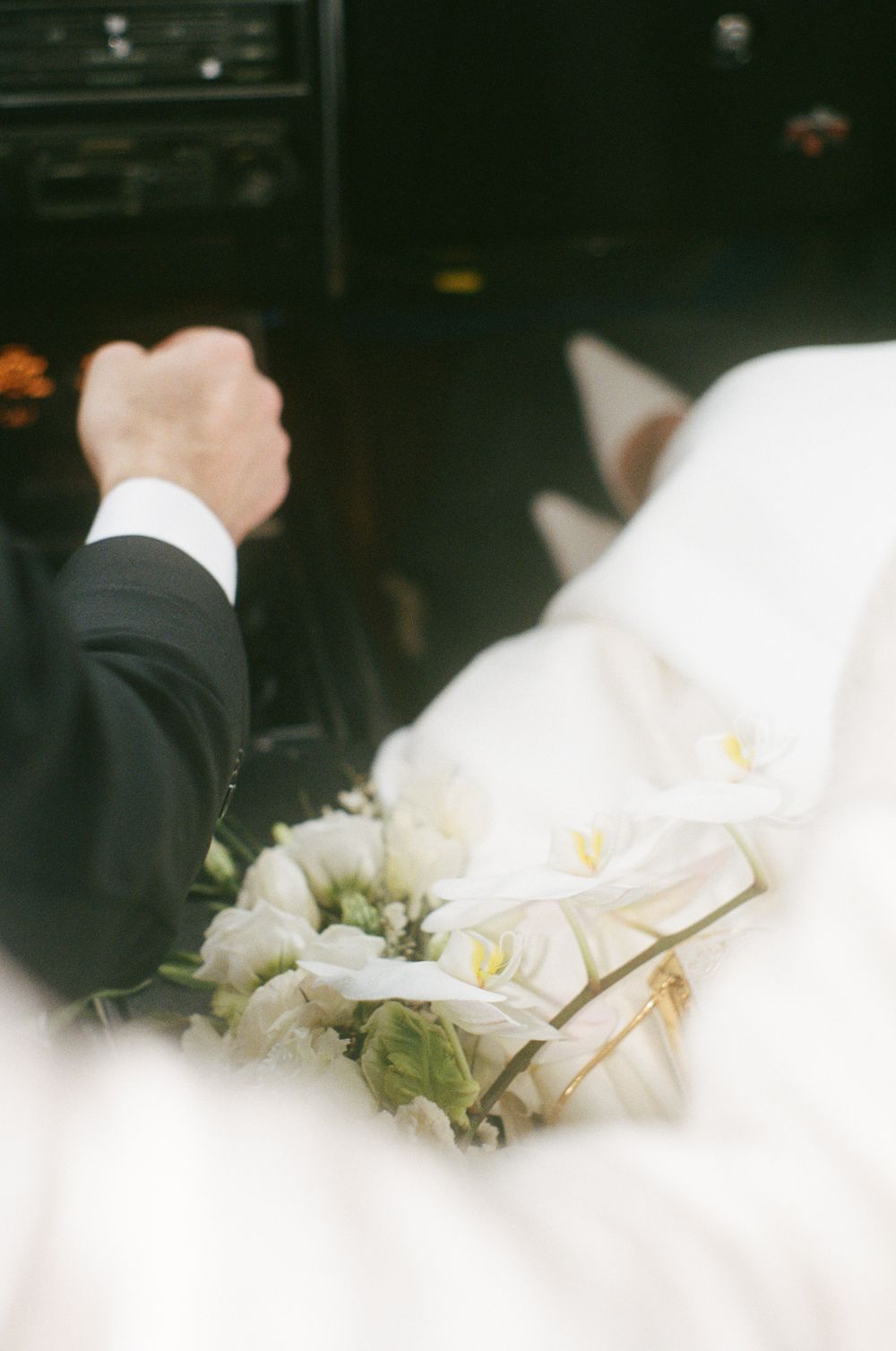 White wedding flowers and decorations in soft focus.