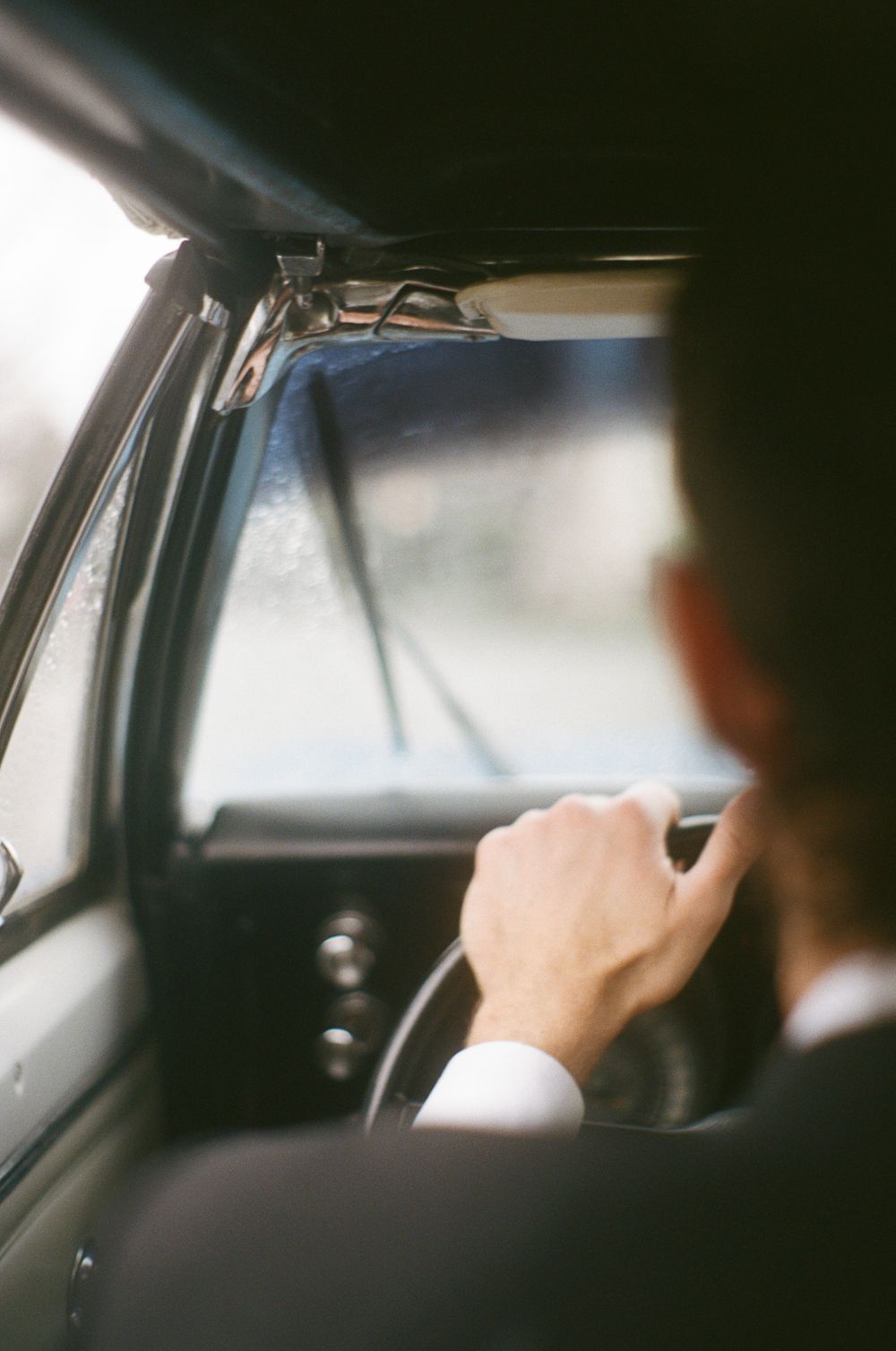Blurred interior shot of a car from behind the driver's seat.