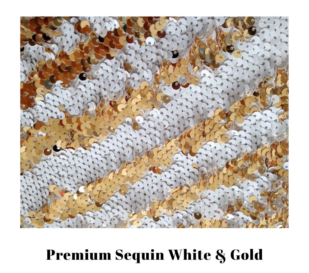 Close-up of diagonal white and gold sequin fabric pattern showing alternating stripes of shimmering texture.