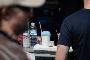 Fast food drink cups and beverages on a tray showing Coca Cola products and soft drinks at a dining establishment.