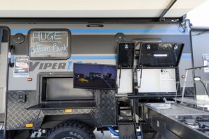 Close up view of electronics and screens mounted on gray mobile vending trailer equipment.