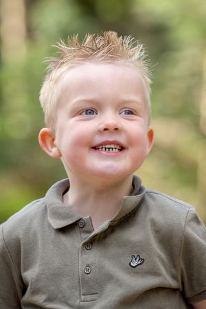 portret van een blond jongetje in groen shirt