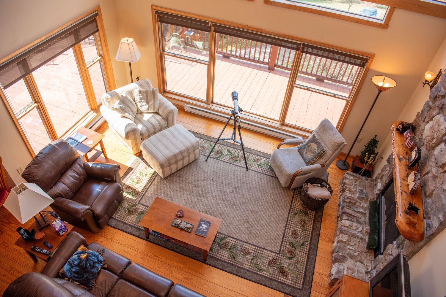 Interior view of a modern living room with natural light streaming through skylights and warm wood accents.