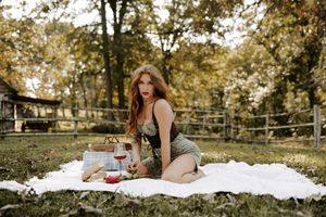 Autumn park picnic setup with white blanket and vintage accessories.