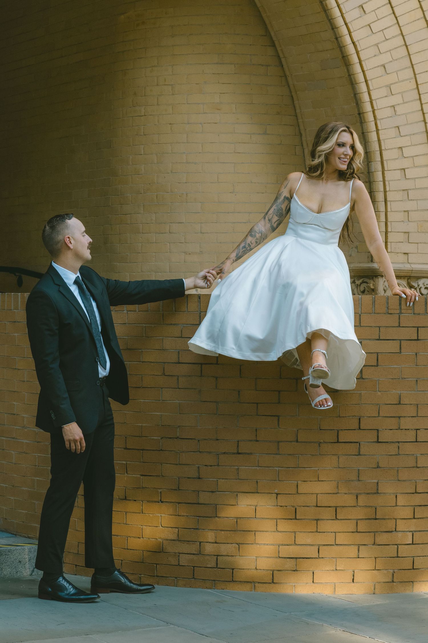 downtown elopement NC SC GA TN tattooed bride model couple holding hands wedding dress courthouse wedding