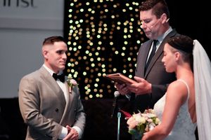 A romantic wedding ceremony moment captured with twinkling lights creating a magical backdrop.