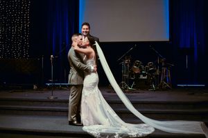 Elegant wedding ceremony setup with twinkling lights and blue drapes creating magical atmosphere.
