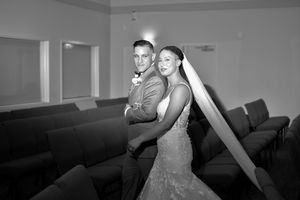 Black and white wedding portrait showing intimate moments in an indoor setting.