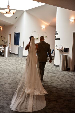 A sequence of photos showing a bride in a flowing white gown walking down a carpeted hallway.