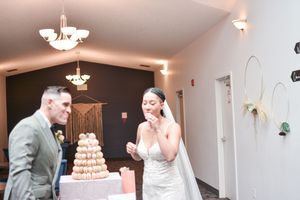 Wedding reception hall decorated with elegant chandeliers and white decor.
