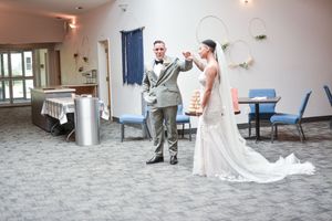 Wedding reception dance sequence showing couple's first dance on carpeted floor.