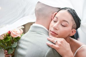 Intimate wedding moment captured in soft, dreamy lighting.