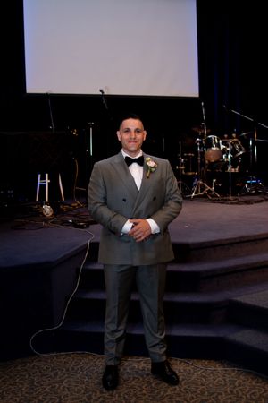 A formal wedding ceremony setup with musical instruments and stage equipment in the background.