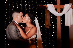 Intimate dance moment captured against backdrop of twinkling fairy lights.