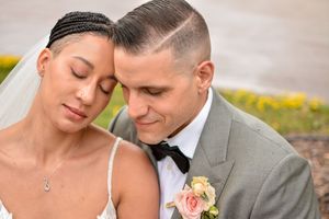 Romantic outdoor wedding portrait with soft natural lighting.