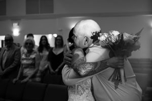 Black and white photo of a couple dancing during their first dance at a wedding reception.