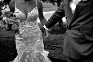 A black and white wedding portrait showing tender moments between the newlyweds.