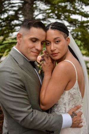 Intimate wedding portraits showing tender moments between newlyweds outdoors.
