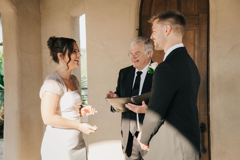 A wedding couple shares intimate moments in a series of candid photos taken against a light-colored wall.