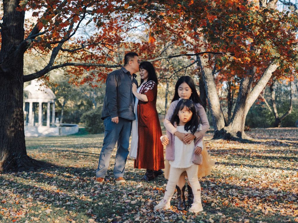 People enjoying a romantic autumn photoshoot in the Larz Anderson Park in Brookline, MA.