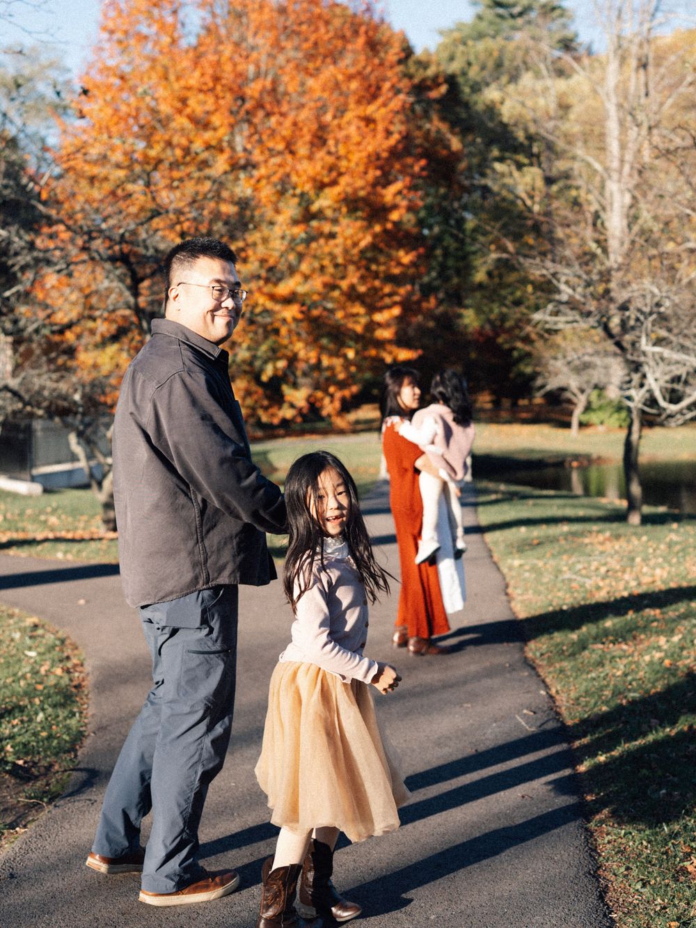People walking together on a path surrounded by autumn trees in the Larz Anderson Park in Brookline.