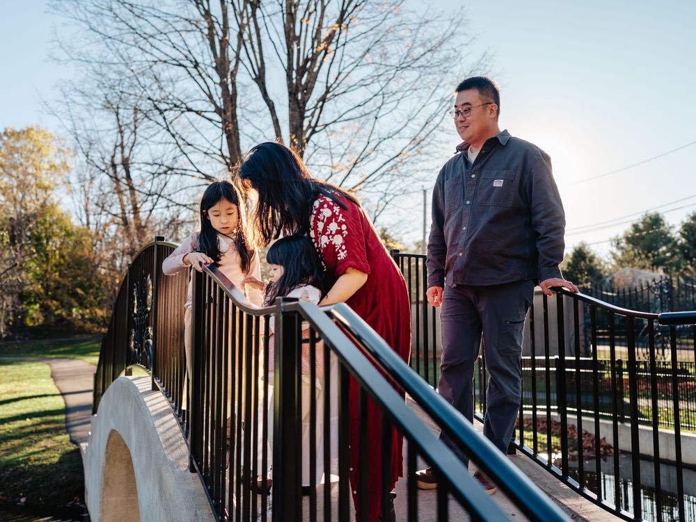 A family on a bridge in the Larz Anderson Park in Brookline, MA