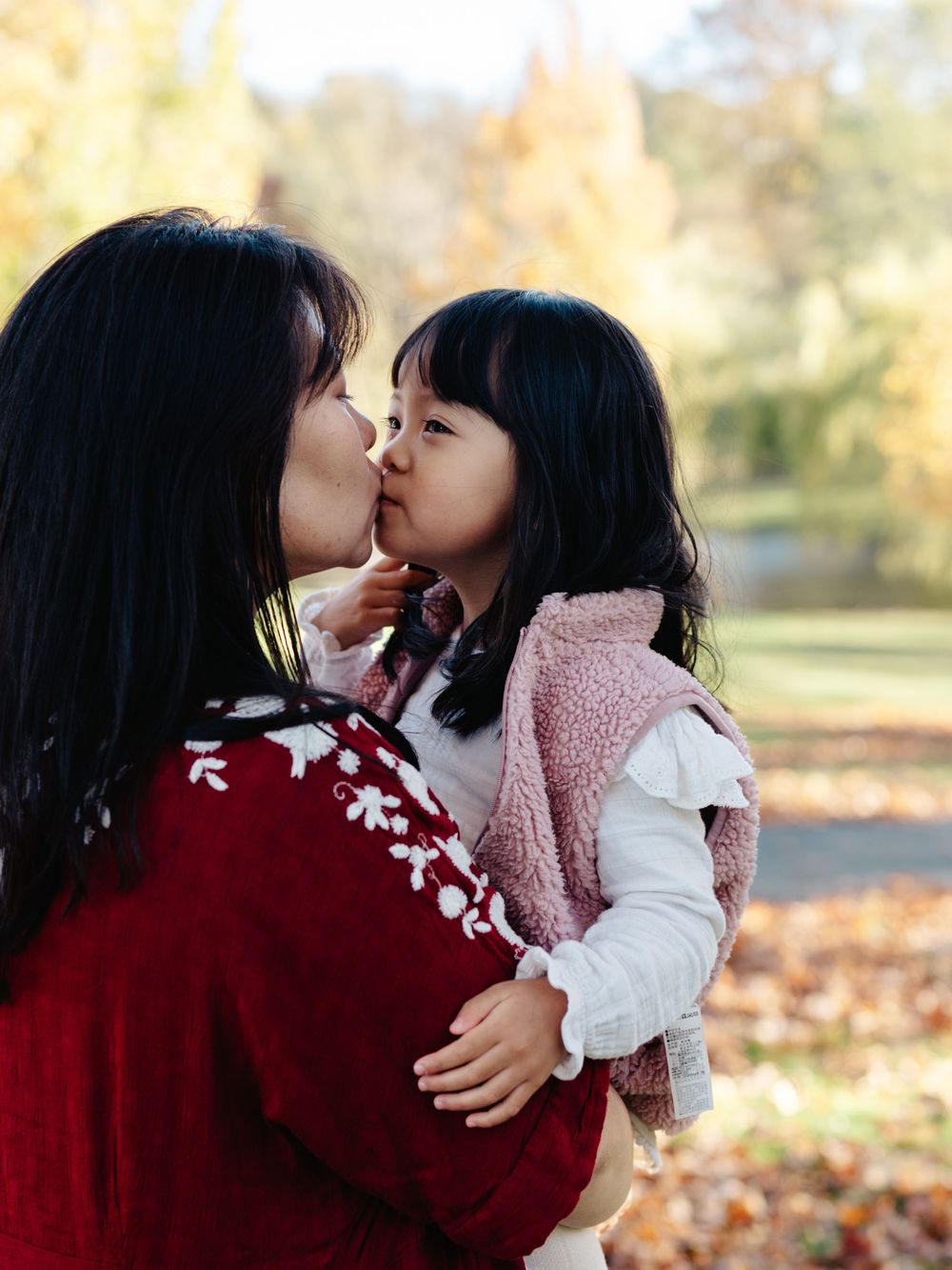 Mother holding her daughter in the Larz Anderson Park in Brookline, MA
