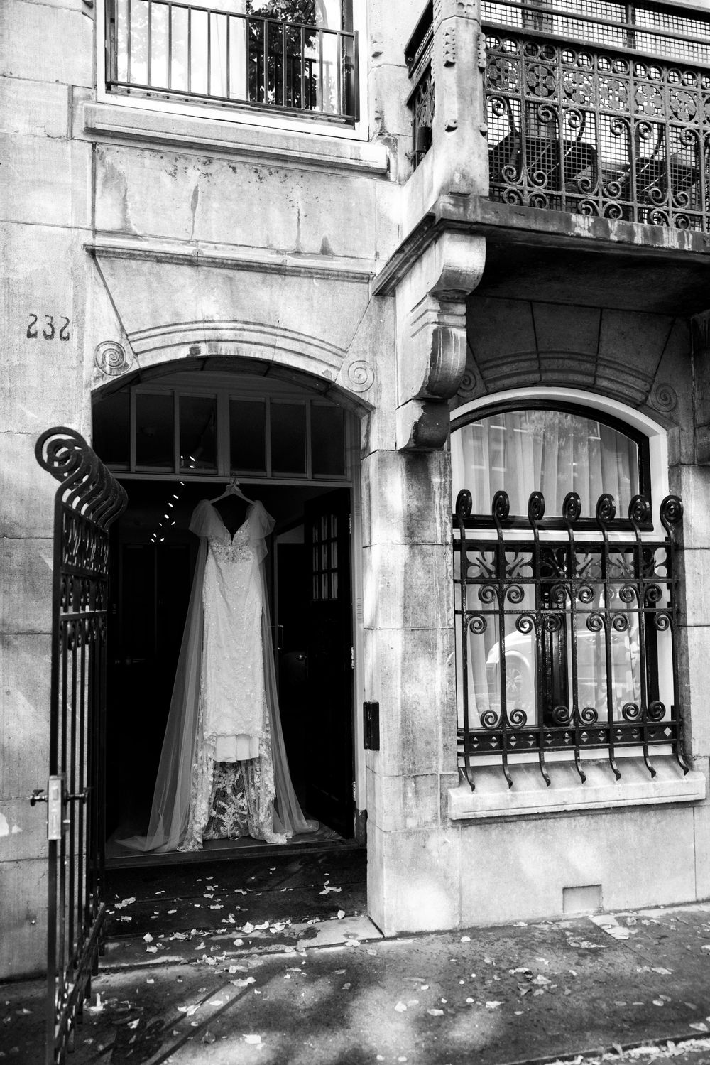 Black and white photo of historic building exterior with ornate iron railings.
