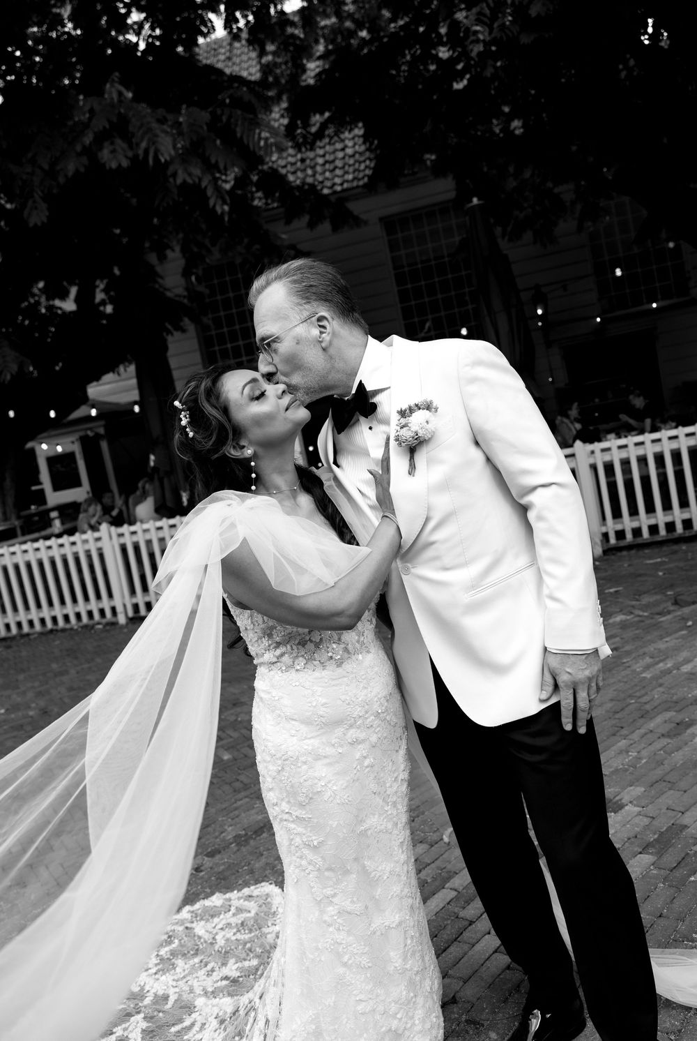 Joyful wedding dance sequence outdoors with flowing white dress and veil.