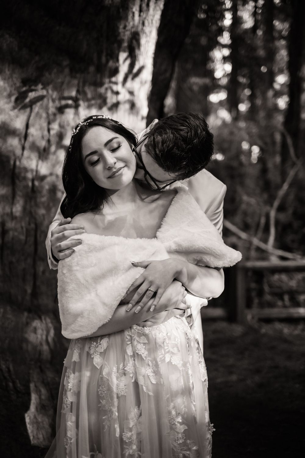 Black and white wedding photos capture tender embraces between newlyweds in a wooded forest setting. Santa Cruz California
