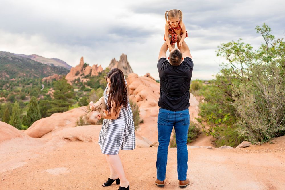 A family of 4 playing at the Garden of the Gods during a family photoshoot