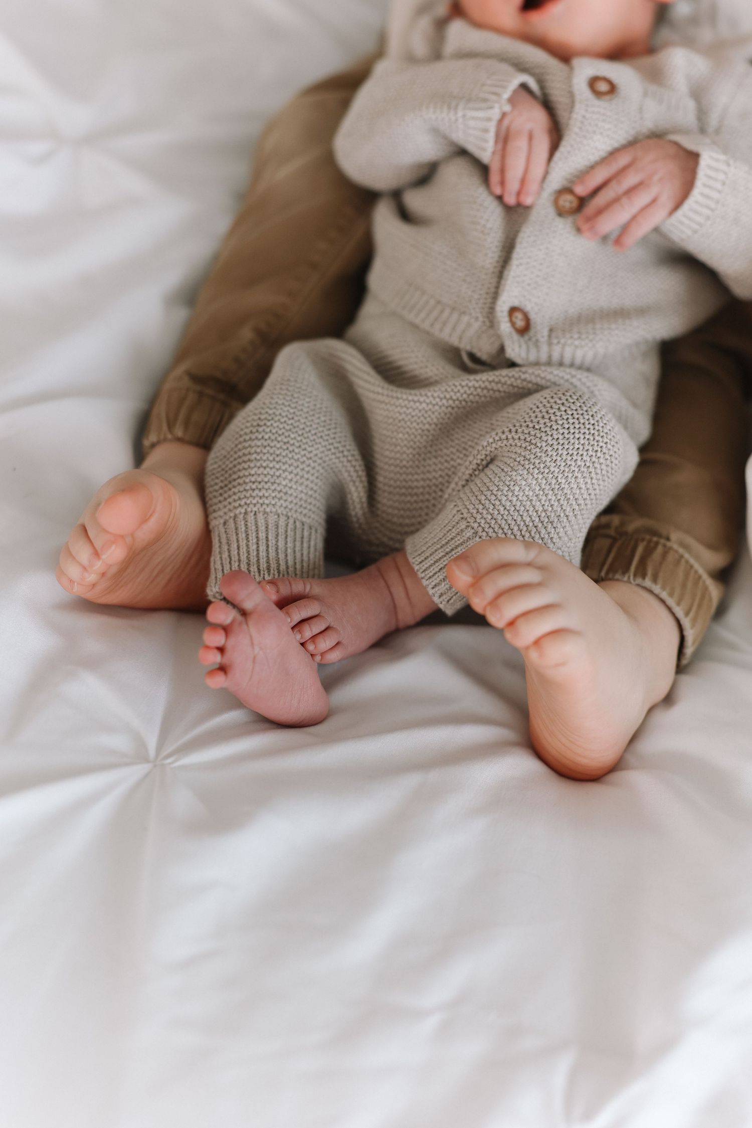 Soft close-up newborn photos of baby and big brother in California