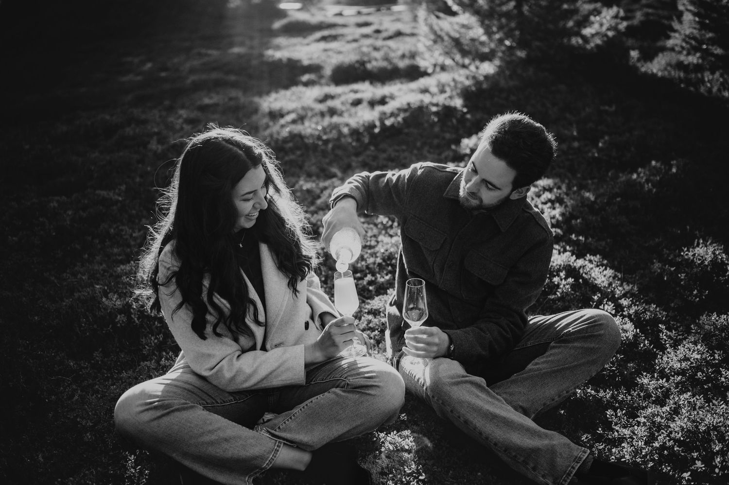 Engagement photographer of couple on Mt. Washington pouring champagne in Paradise Meadows for couple photoshoot Vancouver Island