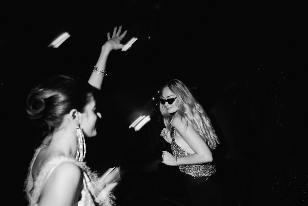 A black and white photo series showing couples dancing closely together at what appears to be a formal event or party.