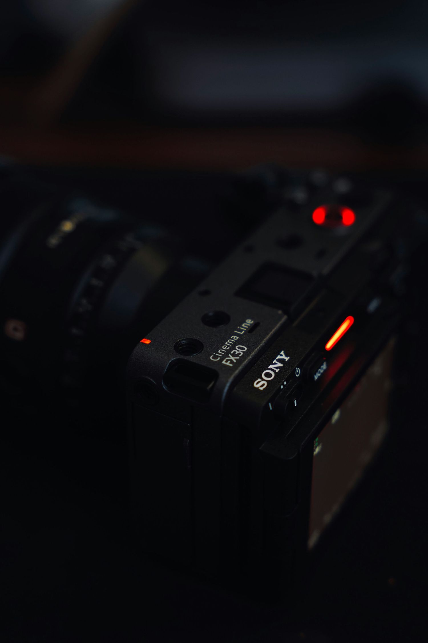 Close-up macro shot of illuminated buttons and controls on electronic equipment in dark lighting conditions.