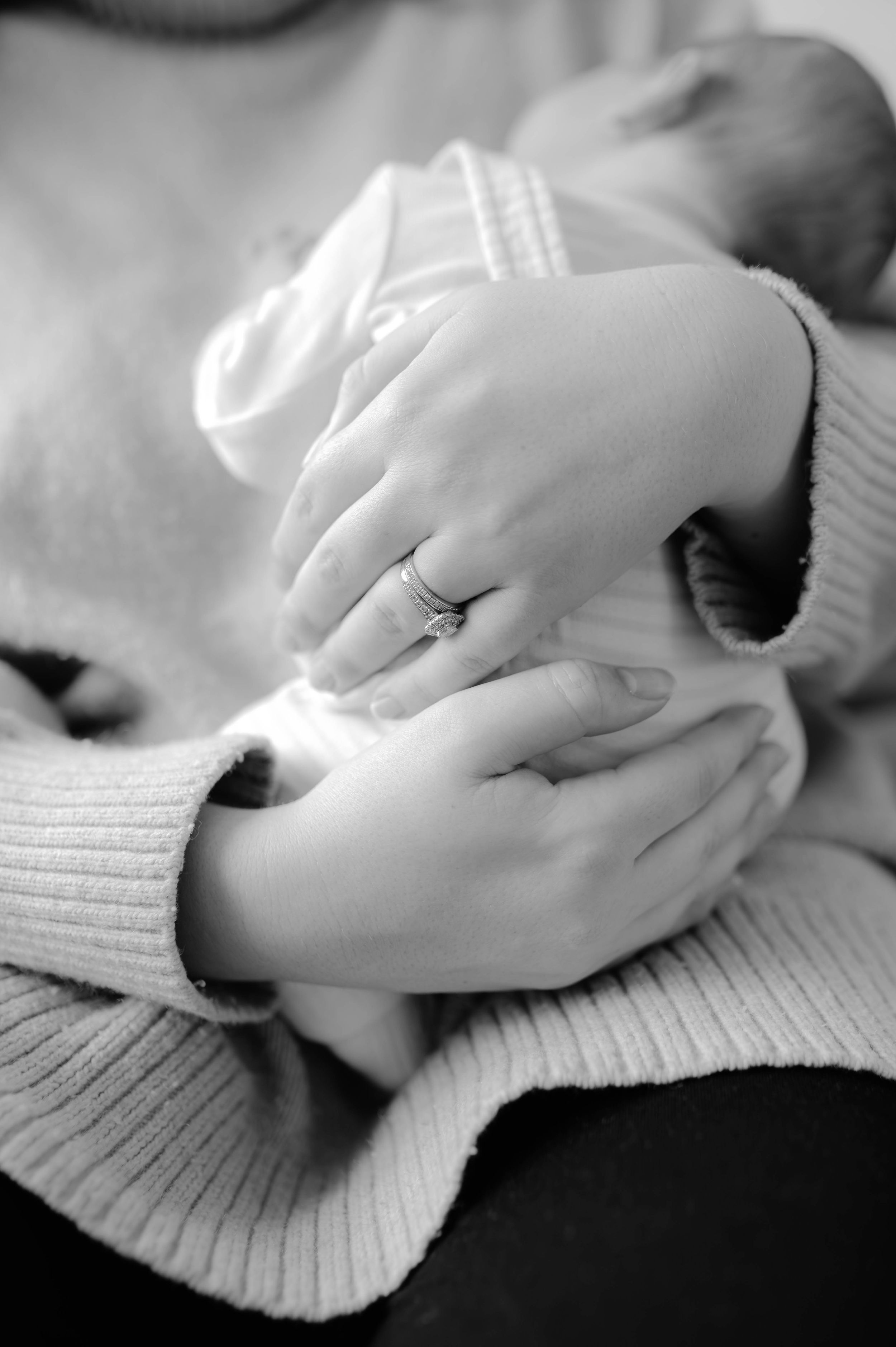 A series of black and white photos showing hands gently resting on a ribbed sweater texture in various positions.