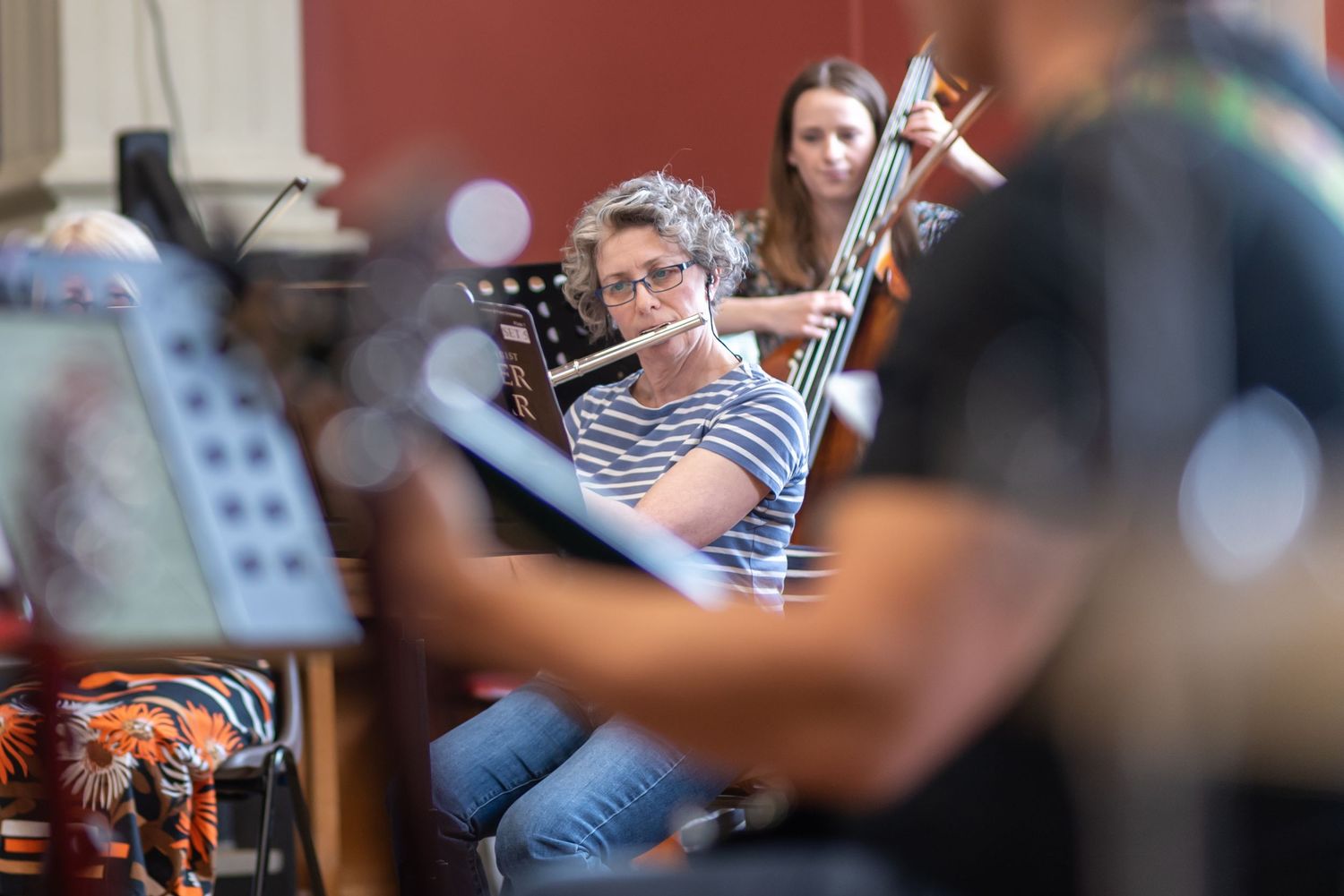 Musicians playing instruments during an informal rehearsal session.