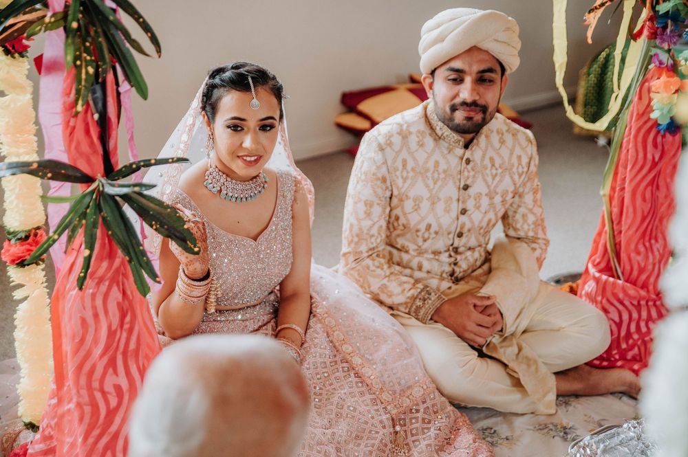 Couple performs traditional wedding rituals with beautifully decorated decor and traditional attire.