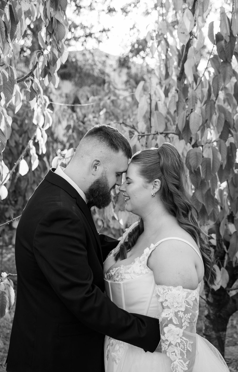 Black and white romantic wedding moment captured through hanging decorative elements.