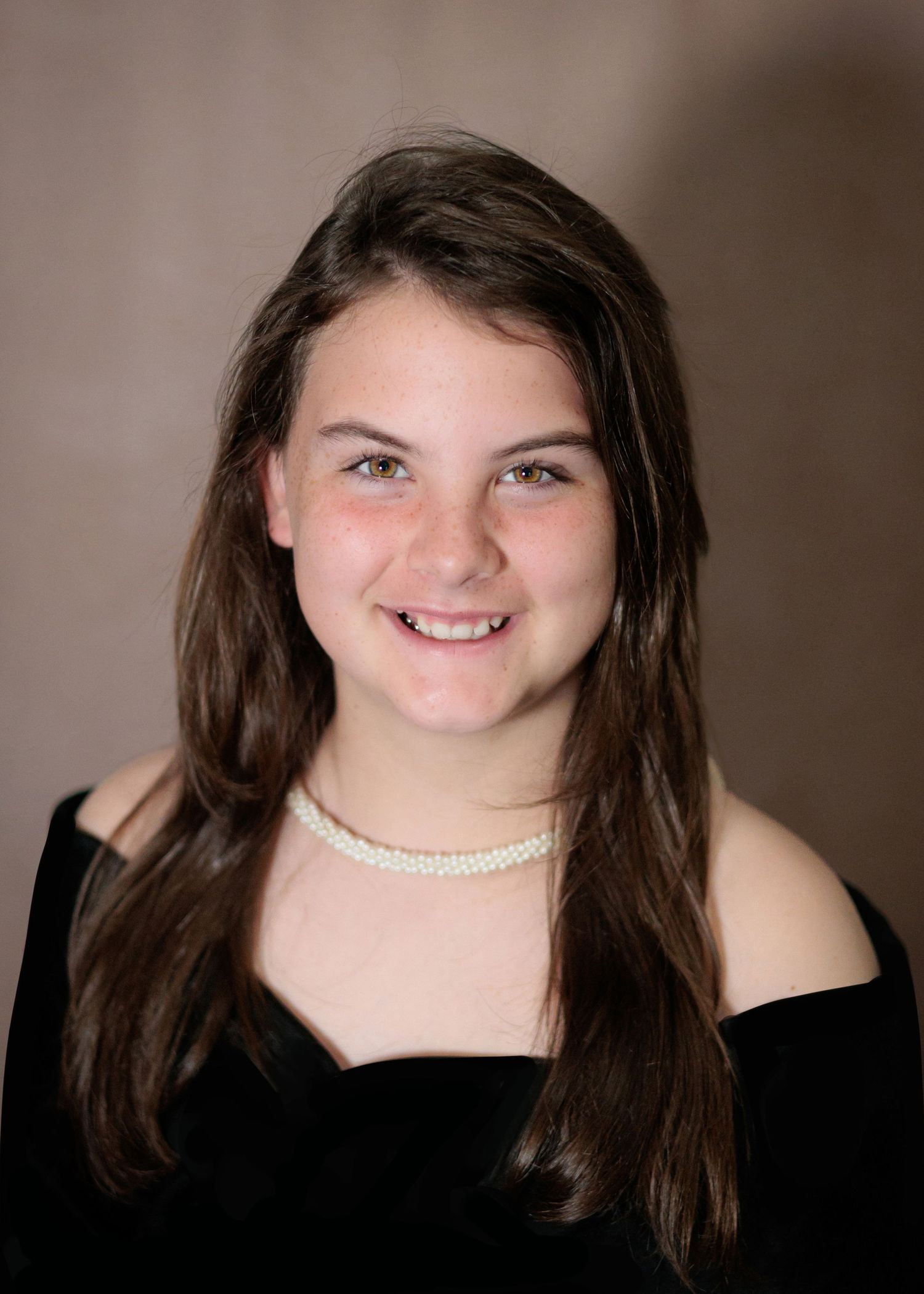 Portrait series showing different poses in black top against brown backdrop.