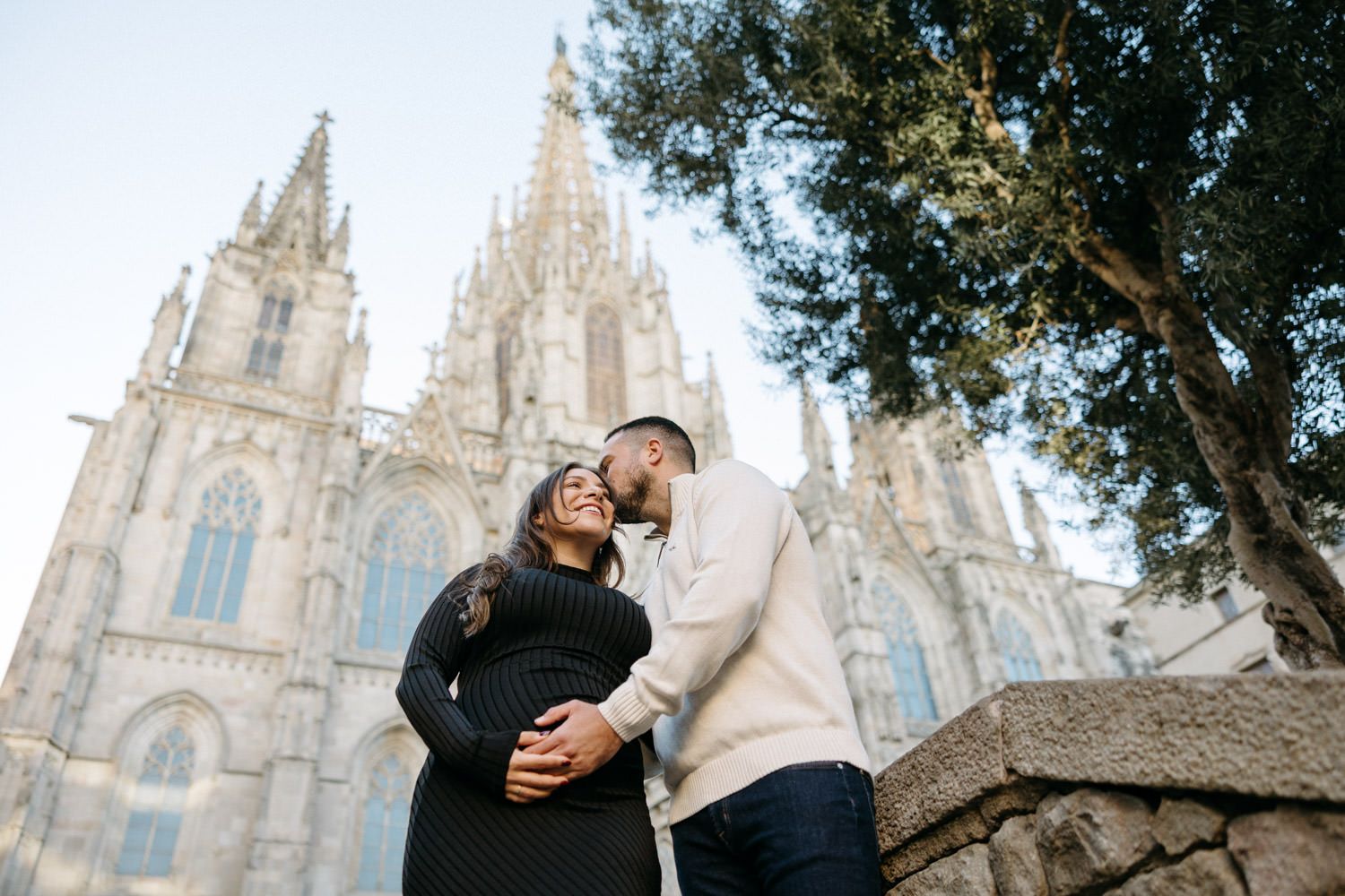 Gothic cathedral spires rise majestically against a bright sky in Barcelona's historic quarter.